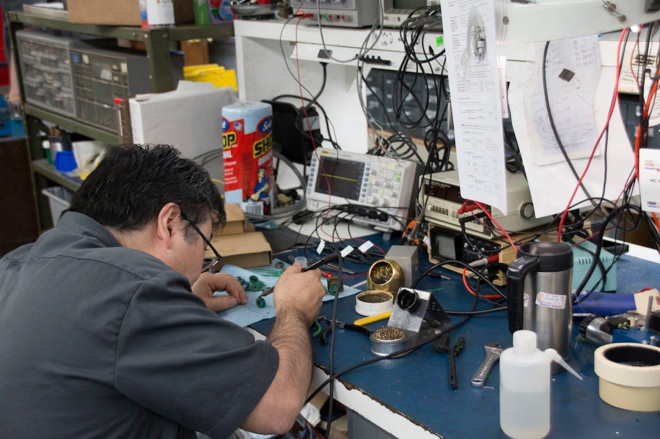 Clean and organized electronics repair station at NC Servo Technology