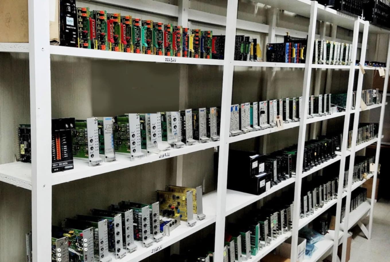 A wall lined with various electronic control units and drives