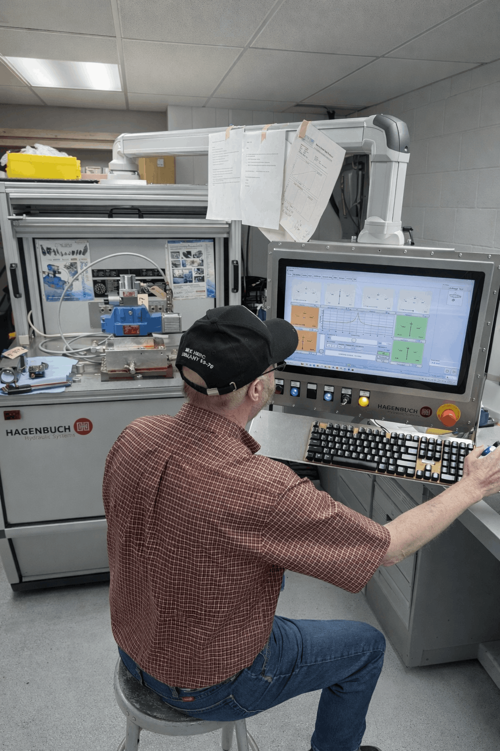 Eddie Harmon working at the Hagenbuch proportional valve test stand at NC Servo Technology.
