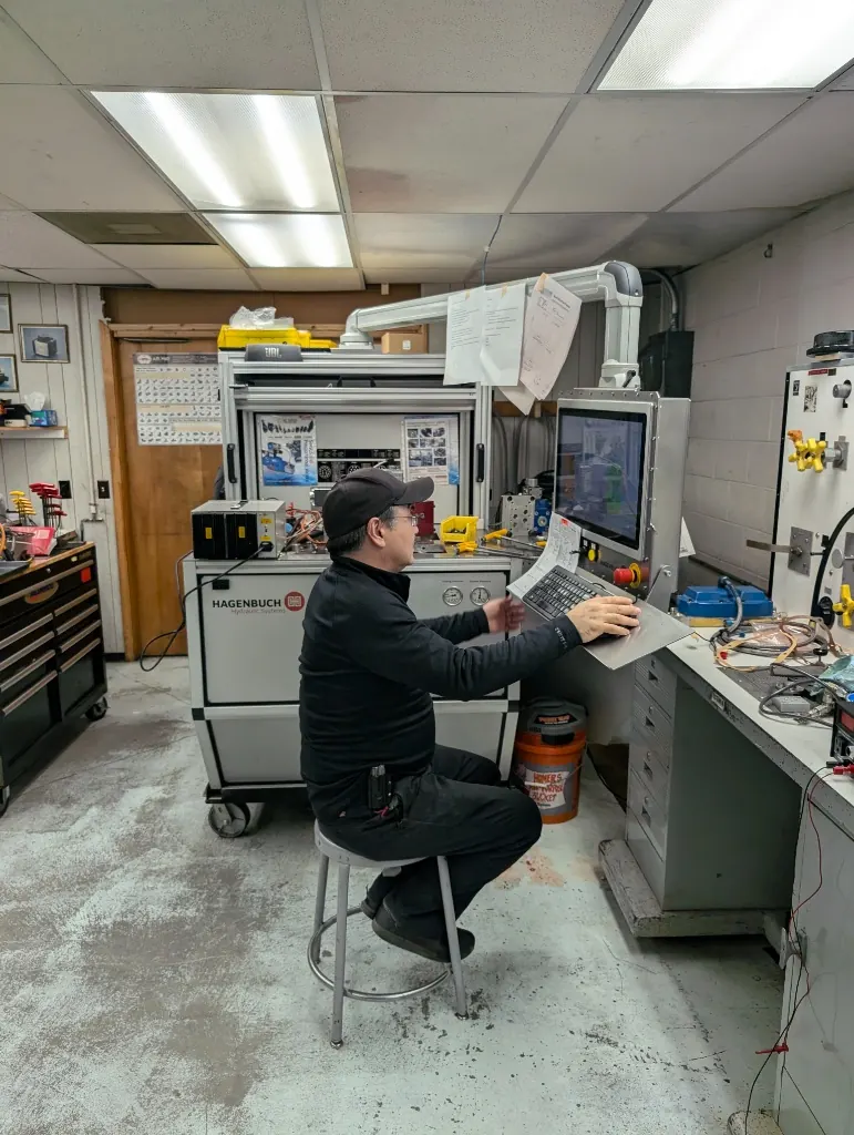 Hydraulic test stand with multiple gauges, valves, and fluid columns for valve performance testing