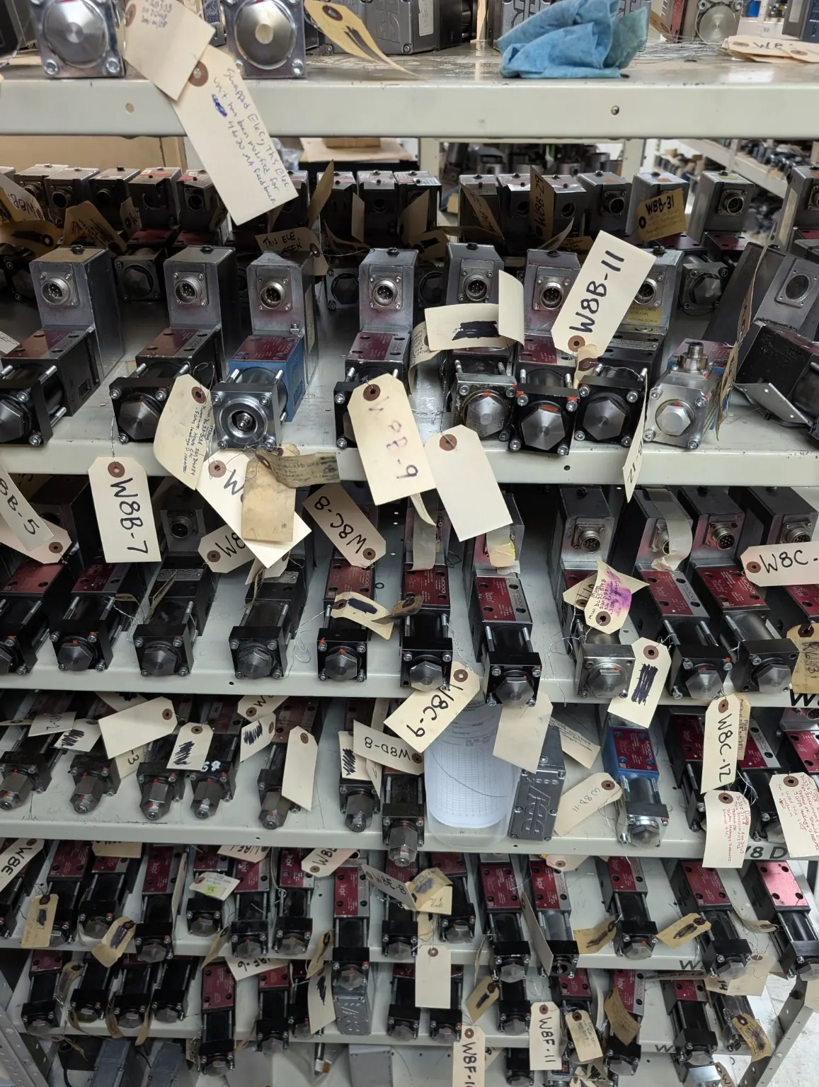 Warehouse shelf with Moog valve and drive components at NC Servo Technology